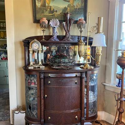 Rounded glass side hutch. One broken glass panel.