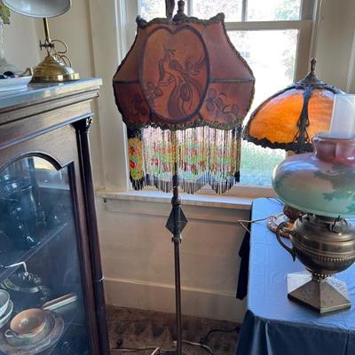 Antique floor lamp with beautiful beaded fringe shade, featuring a bird (potentially a peacock or phoenix) 