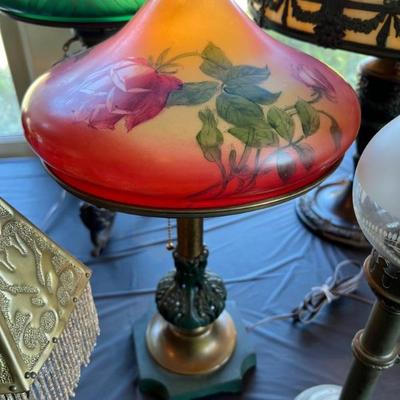 Tables of antique lamps - some stained glass, some reverse painted, some blown glass - something for everyone!