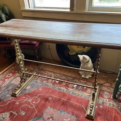 Cast iron or steel based wood table with decorative metal legs marked 