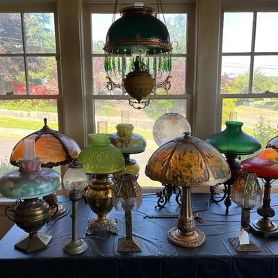 Tables of antique lamps - some stained glass, some reverse painted, some blown glass - something for everyone!