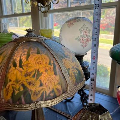 Tables of antique lamps - some stained glass, some reverse painted, some blown glass - something for everyone!