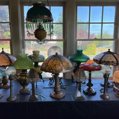 Tables of antique lamps - some stained glass, some reverse painted, some blown glass - something for everyone!
