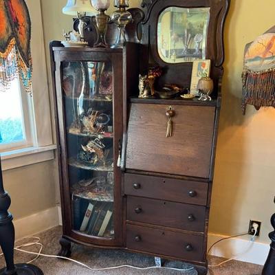 Nice size antique oak secretary desk with glass display door.