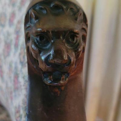 Lion's head on settee arms and feet