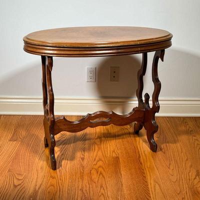 OVAL SIDE TABLE | Walnut Oval Table with cut out sides and shaped stretcher. - l. 32 x w. 18 x h. 27.5 in