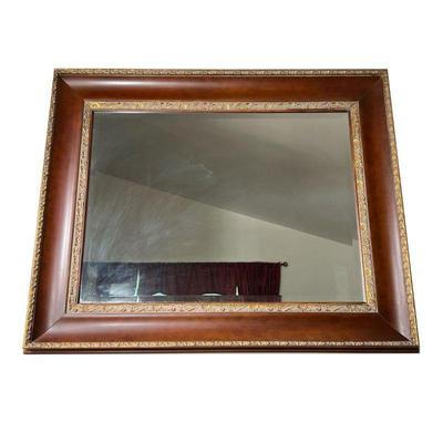 LARGE MIRROR | Large wall mirror with beveled glass, the frame in a dark brown finish with raised gold decoration. - l. 52 x h. 42 in