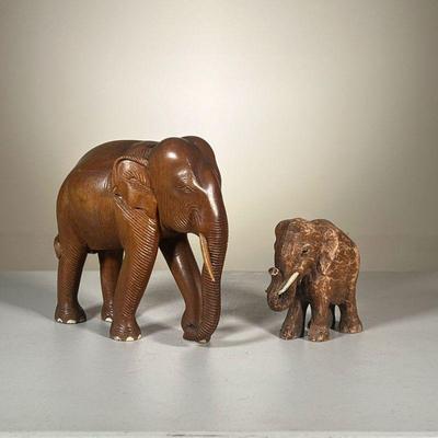 (2PC) CARVED WOODEN ELEPHANTS | Hand-carved wooden elephant figure with a smaller plaster statue.
