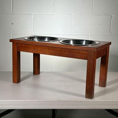 DOG FEEDING STAND | 2 stainless steel dog bowls in wood stand with cutouts. - l. 23.5 x w. 11.5 x h. 12 in
