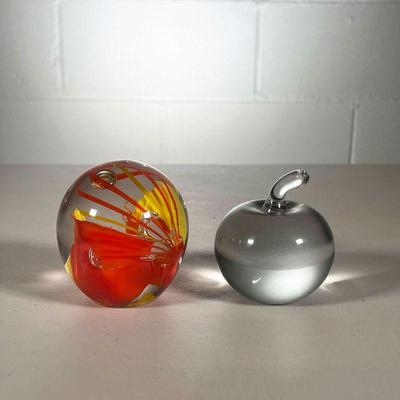 (2PC) GLASS PAPERWEIGHTS | Including one with an orange & yellow design signed by Schneider and one clear glass apple paperweight. - l. 3...