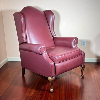 MAROON LEATHER RECLINER | Having a tall back rest with carved claw foot legs in front, reclines with foot rest. - l. 36 x w. 32 x h. 43 in