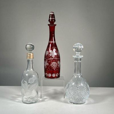 (3PC) DECANTERS; WEDGWOOD & HAWKES | Plus a cut to clear cranberry red glass decanter. - h. 15 in (tallest) 