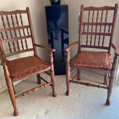 A pair of Sheraton country style, ladder back armchairs, wood with rush seats--they are very comfy; I am sitting in one right now as I...