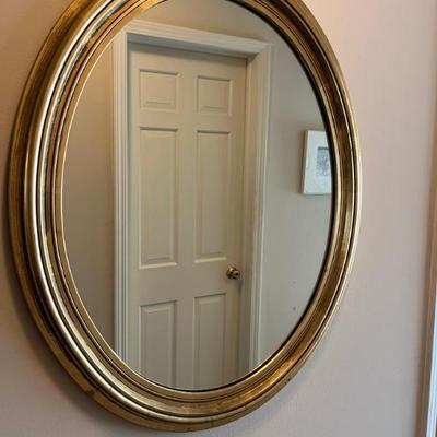gold framed oval mirror