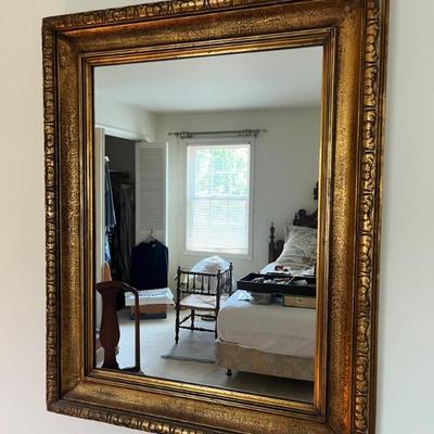 A classic rectangular gold framed mirror