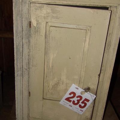 Early 19th century hanging wall cupboard with raised panel door.