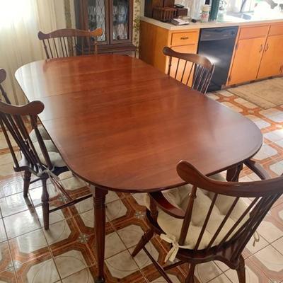 Cherry extension table with 4 windsor chairs, top has always been covered, like-new cond.