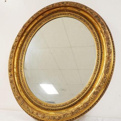 1152	OVAL MIRROR IN GILT FINISHED FRAME, APPROXIMATELY 31 IN X 37 IN
