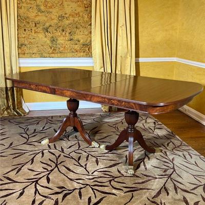 DUNCAN PHYFE DINING TABLE | Double pedestal dining table with brass capped feet, one leaf inserted, accompanied by padded cover and with...
