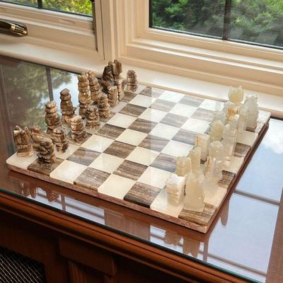STONE CHESS SET | Stone chess board with matching carved stone chess pieces. - l. 14 x w. 14 x h. 1 in