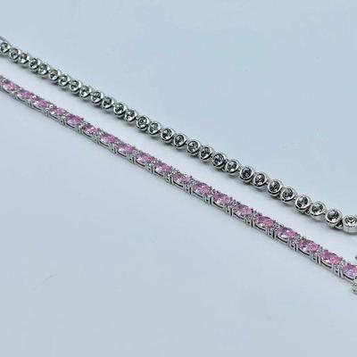 Lot 001-J: Tennis Bracelet Duo

Features: 
â€¢	7â€ Pink and clear sterling silver and CZ bracelet 
â€¢	7â€™ Swarovski crystal and...
