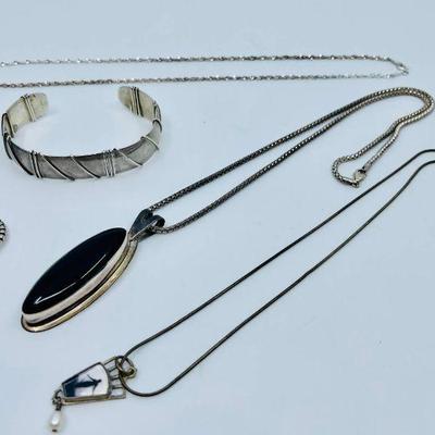 Lot 017-J: Sterling Collection

Includes 5 items:
â€¢	Cuff bracelet
â€¢	Onyx pendant on Sterling chain
â€¢	Gemstone ring
â€¢	Italian...