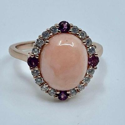 Lot 021-J: Vermeil Coral and Garnet Ring

Features: 
â€¢	Size 8.25 Coral and garnet ring in vermeil setting. Clear stones are Cubic...