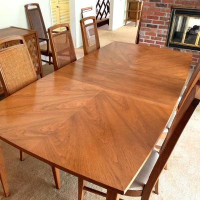 This Broyhill Diamond Head dining table is in excellent condition. The caned backs on all 8 chairs are intact.