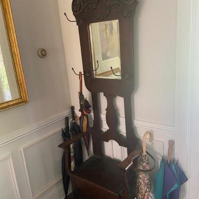 Oak hall tree with storage seat and cast iron umbrella drip-- connector needs repair