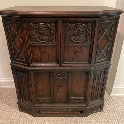 1920"s English Oak Cabinet 
Carved detail borders on door and two doors above and one door to bottom. 35" W x 17" D x...