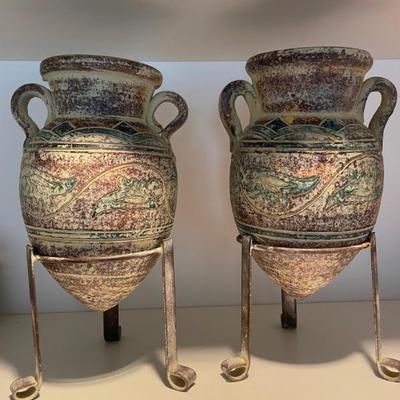 Pair of decorative pottery vases with metal stands