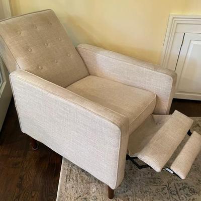 Looking for a place to prop up your feet and relax?  This unobtrusive recliner with a MCM look is a welcome addition to any living space....