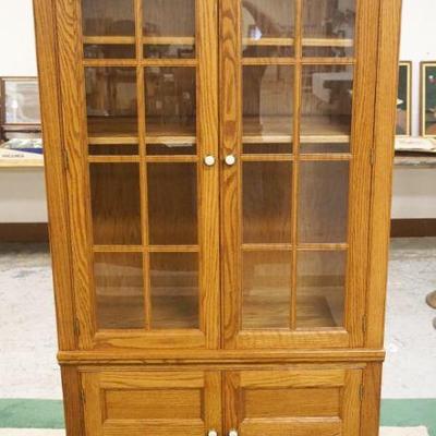 1017	PENNSYLVANIA HOUSE 4 DOOR OAK BOOKCASE WITH INTERIOR LIGHTS AND 2 ADJUSTABLE SHELVES, APPROXIMATELY 36 IN X 20 IN X 79 IN H
