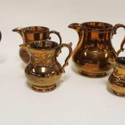 1153	LARGE LOT OF ASSORTED COPPER LUSTER PITCHERS	LARGE LOT OF ASSORTED COPPER LUSTER PITCHERS, LARGEST APPROXIMATELY 5 1/2 IN HIGH
