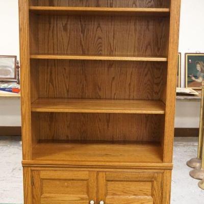 1016	PENNSYLVANIA HOUSE OAK BOOKCASE WITH 3 ADJUSTABLE SHELVES AND 2 DOOR STORAGE AT BOTTOM, APPROXIMATELY 36 IN X 20 IN X 79 IN H
