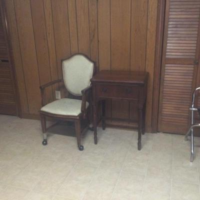 Sewing machine in cabinet, chair on casters