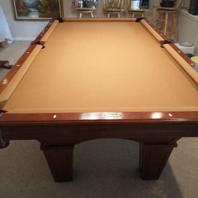 Pool table is 8 ft x 4 ft. It includes the billards lamp and pool cues and stand