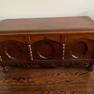 a really lovely carved trunk, cedar lined--it's a great size and height--it can easily double as a bench or coffee table