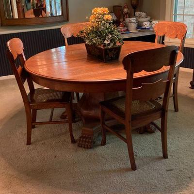 Round oak table with split base and harry paw feet