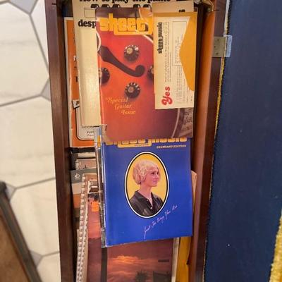 Several piano books in the bench