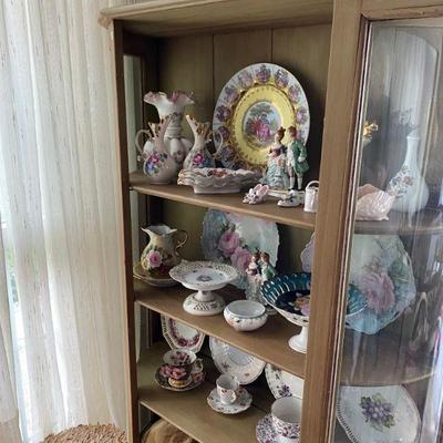 Antique China Cabinet filled with porcelain figurines and decoratives