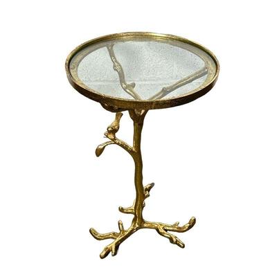 MANNER OF DIEGO GIACOMETTI METAL SIDE TABLE | Round pedestal side table with glass top and cast metal supports with a bird resting upon a...