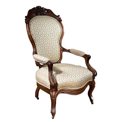 Gentlemenâ€™s Chair | Carved walnut chair with floral crowning on top and floral cream cushioning. - l. 30 x w. 26 x h. 43 in 