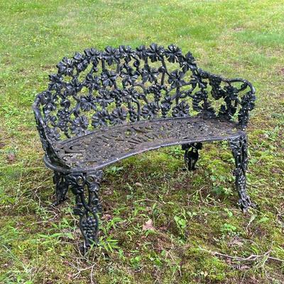 Wrought Iron Bench | Small wrought iron garden bench painted black with grapevine motifs composing the seat, back, and legs. - l. 38 x w....