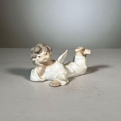 Lladro Angel Figure | Lladro angel laying down figurine; matte porcelain finish; signed on bottom, #9. - l. 5.5 x h. 2.5 in 