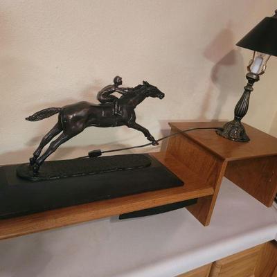 Desk shelf with horse statue and lamp