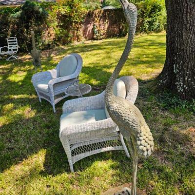 Bronzed herons, one is a water feature