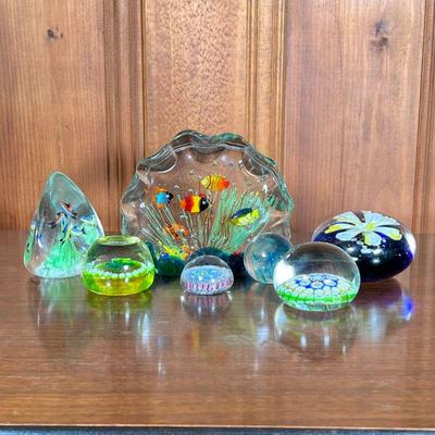(7PC) COLORFUL GLASS PAPERWEIGHTS | Includes; 2 large aquatic paperweights with fish and sea life, floral and clover paperweight, and...