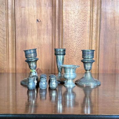 (9PC) MISC STERLING SILVER | Includes: 6 small Sterling salt & pepper shakers, 2 sterling candlesticks and other miscellaneous items. -...