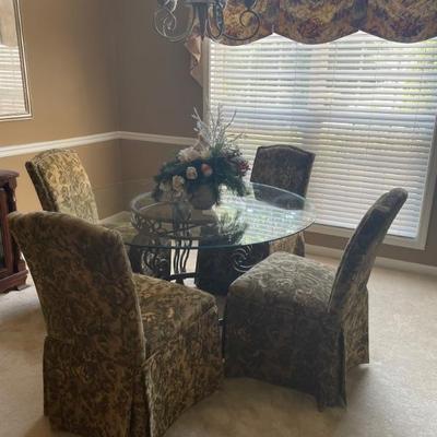 Glass top dining room table with fabric chairs